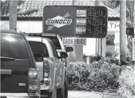  ?? MARTA LAVANDIER/AP ?? The Heritage Foundation says President Joe Biden’s energy policies are helping drive inflation higher. Above, cars at a gas station April 13 in Delray Beach, Florida.