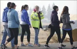  ?? KARL MONDON — STAFF PHOTOGRAPH­ER ?? Mel Contant (center) works as a volunteer coordinato­r helping Camp Fire evacuees at the Walmart tent city in Chico on Sunday.