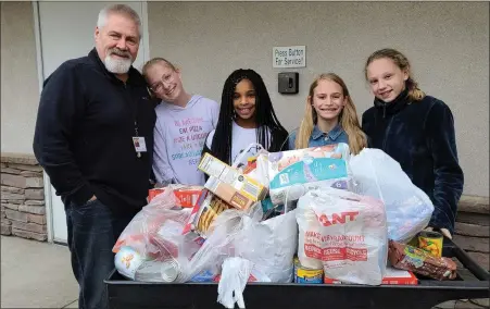  ?? SUBMITTED PHOTO ?? Pastor Gil and youth making a food donation to Boyertown Area Multi-Service. Preston’s Pantry distribute­d 5,008pounds of pantry items last week, serving 67adults and 45children in a modified drive-thru manner. Families received shelf stable and frozen foods, fresh produce, eggs, and dairy, pet food, formula, baby food, diapers, and personal care items.