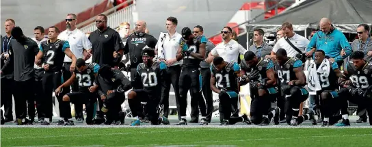  ?? PHOTO: REUTERS ?? Jacksonvil­le Jaguars players kneel during the US national anthem before the match against the Baltimore Ravens at Wembley Stadium in London.
