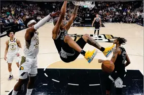  ?? AP PHOTO BY ERIC GAY ?? San Antonio Spurs forward Jeremy Sochan, center, scores past Indiana Pacers guard Buddy Hield (24) during the second half of an NBA basketball game in San Antonio, Thursday, March 2, 2023.