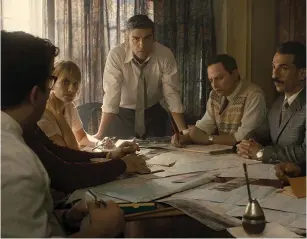  ?? (Valeria Florini/MGM) ?? OSCAR ISAAC as Mossad operative Peter Malkin (standing) and comedian Nick Kroll as the Mossad’s Rafi Eitan (second right) in a scene from ‘Operation Finale.’