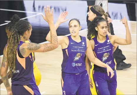  ?? Phelan M. Ebenhack / Associated Press ?? Mercury guard Diana Taurasi, center, is congratula­ted by Brittney Griner, left, and Skylar Diggins-Smith after scoring against the Los Angeles Sparks on Saturday.