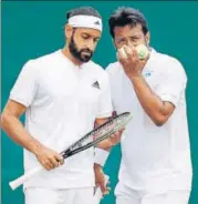  ?? AFP ?? Leander Paes (R) and his partner Adil Shamasdin confer between points during their Wimbledon first round match on Thursday.