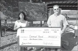  ??  ?? Denise Redmond, Executive Director of Carousel Ranch, receives check from Rawleigh Smith, president of Choices in Learning National Foundation.
