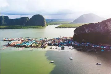  ??  ?? The fishing village on stilts: Koh Panyi, one of the stops on our Thailand Flotilla