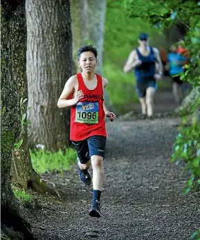  ?? SUPPLIED ?? Addison Stewart leads the pack during the Waitakere half and fun runs event.