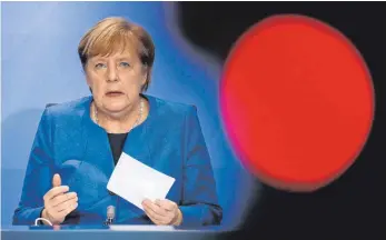  ?? FOTO: F. BENSCH/AFP ?? Kanzlerin Angela Merkel sprach von einem „schweren Tag“, als sie die Maßnahmen gegen Corona verkündete.
