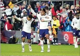  ?? JULIO CORTEZ / AP ?? The United States’ Weston McKennie celebrates his goal with Tyler Adams, left, and Christian Pulisic during the second half of a FIFA World Cup qualifying soccer match against Mexico on Friday in Cincinnati. The U.S. won 2-0.