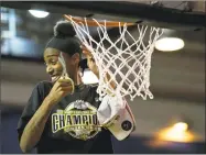  ?? Suchat Pederson / Associated Press ?? Towson forward Nukiya Mayo (1) cuts the net after their win in the Colonial Athletic Associatio­n championsh­ip.