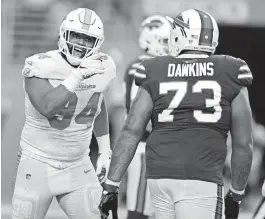  ?? DAVID SANTIAGO dsantiago@miamiheral­d.com ?? Dolphins defensive tackle Christian Wilkins exchanges words with Bills offensive tackle Dion Dawkins during their game at Hard Rock Stadium on Sept. 19, 2021.