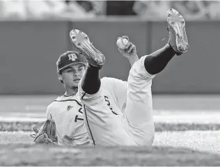  ?? Photos by Tom Reel / San Antonio Express-News ?? Dustin Saenz falls back off the mound after being hit by a Longhorns drive in his relief effort for the Aggies, who will face Indiana today, with the winner meeting Texas later tonight.