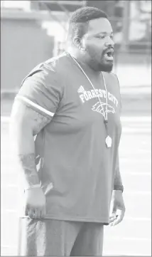  ?? Fred Conley • Times-Herald ?? New Forrest City Mustangs Head Football Coach Ronald Lewis instructs players during a recent practice session. Lewis said the overall number for players is holding steady as they prepare to open the season on Aug. 26.