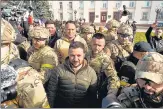  ?? REUTERS ?? President Volodymyr Zelensky speaks to people in central Kherson, Ukraine, on Monday.