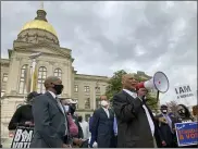  ??  ?? African Methodist Episcopal Church Bishop Reginald Jackson announces a boycott of Coca-Cola Co. products outside the Georgia Capitol in Atlanta.