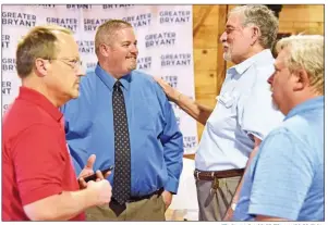  ?? STACI VANDAGRIFF/TRILAKES EDITION ?? During a meet and greet on July 17, Jason Brown, back left, the new chief executive officer for the Greater Bryant Chamber of Commerce, visits with Ray Baggett, back right, a Farmers Insurance agent. In the foreground are Mark Hoffpauir, left, of First Security Bank, and David Hannah, chairman of the board of directors for the chamber.