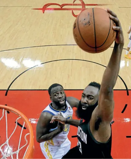  ?? AP ?? Houston Rockets guard James Harden scores despite the attention of Golden State Warriors forward Kevon Looney.