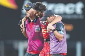  ?? ?? A despondent Lachie Weller is helped from the field during the Suns’ win over the Roos at TIO Stadium. Picture: AFL Photos via Getty