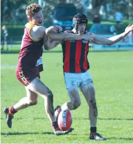  ??  ?? Liam Anderson, a key part of Drouin’s backline group, blocks opponent Josh Davis’ path to the ball as the Hawks took control on their way to their best win of the season.