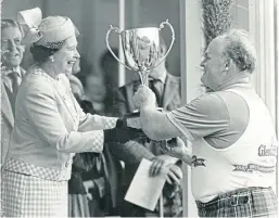  ??  ?? The Queen presents a trophy to Bill Anderson at the Braemar Gathering in September 1987.