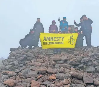  ?? ?? Achievemen­t The climbers at the summit of Ben Macdui