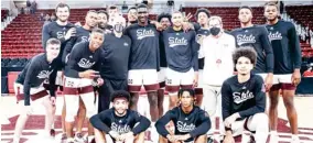  ??  ?? Mississipp­i State players, head coach Ben Howland and Athletic Director John Cohen surround Abdul Ado and Jalen Johnson after they were recognized during senior night ceremonies at Humphrey Coliseum on Saturday. (Photo by Austin Perryman, MSU Athletics, for Starkville Daily News)