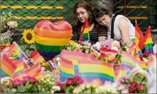  ?? Sergei Grits / Associated Press ?? People comfort each other Saturday at the scene of a shooting in Oslo, Norway. A gunman who opened fire in Oslo’s nightlife district killed two people and left more than 20 others wounded during the LGBTQ Pride festival.