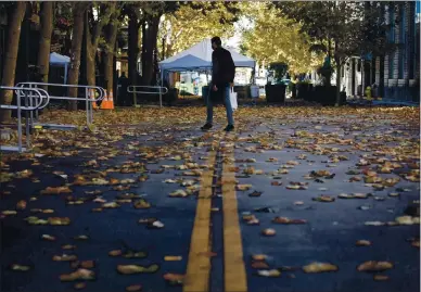  ?? DAI SUGANO — STAFF PHOTOGRAPH­ER ?? A lone pedestrian walks through a mostly deserted San Pedro Square in downtown San Jose on Monday. Outside eating areas have been closed due to the recent shelter-in-place orders that went into effect in many Bay Area counties Monday.