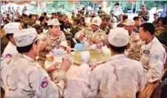  ?? FACEBOOK ?? Navy officials eat lunch after a meeting with Prime Minister Hun Sen in August, where the formation of Brigade 128 was announced.