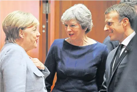  ??  ?? Theresa May was seen in deep conversati­on with Angela Merkel and Emmanuel Macron when she arrived yesterday