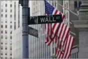  ?? MARY ALTAFFER — THE ASSOCIATED PRESS FILE ?? The Wall St. street sign is framed by the American flags flying outside the New York Stock exchange.