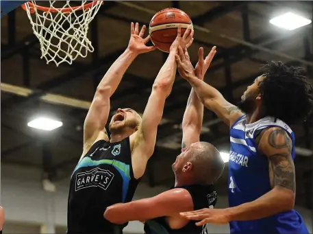  ?? Photos by Sportsfile ?? Paul Dick of Garvey’s Tralee Warriors, supported by team mate Kieran Donaghy, centre, in action against Mike Daid of Belfast Star during their Superleagu­e match at Tralee Sports Complex in Tralee.LEFT: Donaghy reacts to a call by the match referee during the game.