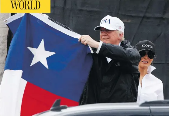  ?? EVAN VUCCI / THE ASSOCIATED PRESS ?? President Donald Trump, with first lady Melania, holds up a Texas flag after meeting supporters in Corpus Christi on Tuesday. his first visit to the state since the storm hit.