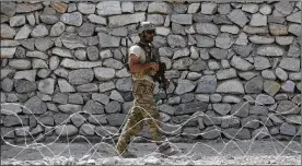  ?? RAHMAT GUL / AP ?? A U.S. soldier patrols in Asad Khil village last month in the Achin district of Jalalabad, Afghanista­n. As the 16-year-old war grinds on, Afghan soldiers are suffering what Pentagon auditors call “shockingly high” battlefiel­d casualties.