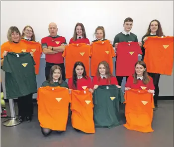  ??  ?? Pupils and staff holding T-shirts featuring the new logo: Back row, from left: Lorna McKinven, Beckie Shields, Jim Farren, Emma McKinven, Krystal Allen, Callum Miller, and Lizzie Bell. Front: Ellie McNair, Jasmine Kolibska, Chloe Croft, and Jade Graham.