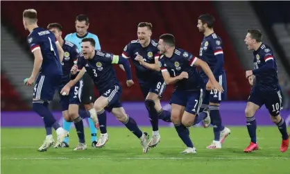  ?? Photograph: Russell Cheyne/ Reuters ?? The Scotland players charge towards Kenn McLean after his winning penalty in the shootout against Israel.