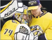  ?? MARK HUMPHREY — ASSOCIATED PRESS ?? The Predators’ Juuse Saros (74) is hugged by fellow goalie Pekka Rinne after Saros stopped 43 shots in a 1 -0 win.