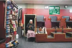  ?? AP PHOTO/MARY ALTAFFER ?? Bertha Gomez shines a shoe Feb. 3 while waiting for customers at the Alpha Shoe Repair Corp. in New York.
