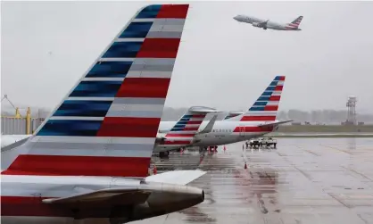  ??  ?? American Airlines aircraft at Ronald Reagan Washington national airport, Arlington, Virginia. The US aviation industry is to receive $60bn in the government’s coronaviru­s relief package. Photograph: Michael Reynolds/EPA