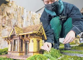  ?? ?? Margeaux Lim fills in the landscapin­g around a miniature house earlier this month.
