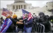  ?? ASSOCIATED PRESS FILE PHOTO ?? Rioters try to break through a police barrier at the Capitol in Washington.