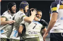  ?? PHOTO: GETTY IMAGES ?? You beauty . . . Highlander­s openside flanker Billy Harmon is swamped by (from left) Bryn Evans, Josh Dickson and Aaron Smith, after scoring a try during the win over the Brumbies in Canberra on Friday night.