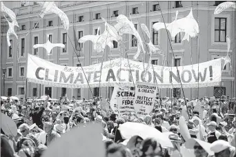  ?? ANDREW MEDICHINI/ASSOCIATED PRESS ?? Last Sunday, Pope Francis praised environmen­tal demonstrat­ors who arrived at St. Peter’s Square. Their route began near the French embassy to remind people of a climate change conference in Paris later this year.