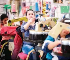  ?? NIKOLAY DOYCHINOV/AFP ?? Employees work in a sewing factory in the northern town of Lovech, on February 24.