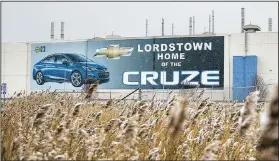  ?? AP/JOHN MINCHILLO ?? A banner depicting the Chevrolet Cruze model vehicle is displayed at the General Motors plant in Lordstown, Ohio, in November. GM closed the plant earlier this month.