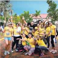  ?? CONTRIBUTE­D ?? Dr Chris Tufton, minister of health (centre, back row), sharing a moment with members of the Victoria Mutual Building Society team at the JN Foundation Heroes in Action Run/Walk.