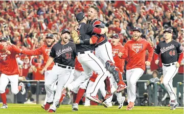  ?? USA TODAY SPORTS ?? Washington catcher Yan Gomes, right, hugs relief pitcher Daniel Hudson as they celebrate their victory over St Louis in Game Four of their National League Championsh­ip Series.