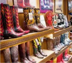  ??  ?? Custom designed boots line the shelves at Little’s Boot Company.