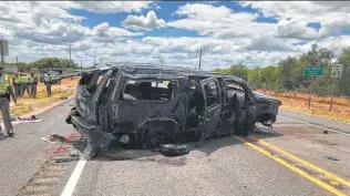  ?? David Caltabiano / KABB / WOAI / Associated Press ?? Four people died at the scene on Texas 85 in Big Wells and a fifth died on the way to a hospital after a Suburban rolled while being chased by Border Patrol and Dimmit County deputies.