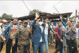  ?? Ethiopian Office of Prime Minister / Getty Images ?? Ethiopian Prime Minister Abiy Ahmed walks to his polling location in his home city of Beshasha last month to vote in the national election. Abiy will serve a second fiveyear term.